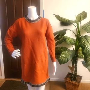 S/M Burnt Orange sweater/dress with black and white fringe on neck and hem.